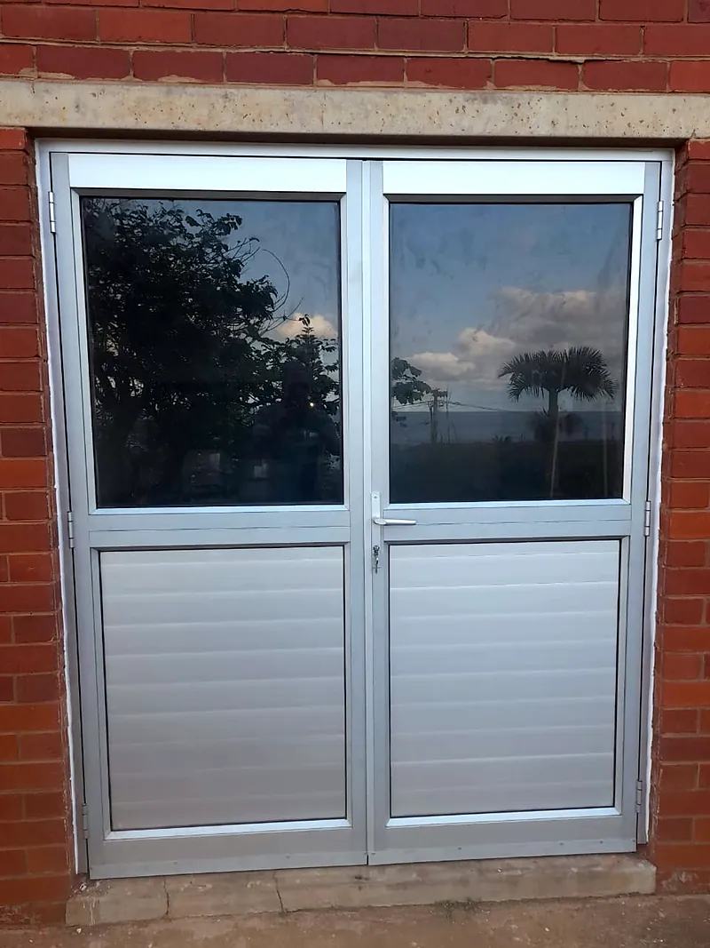 After: aluminium double doors with glass above and louvres below