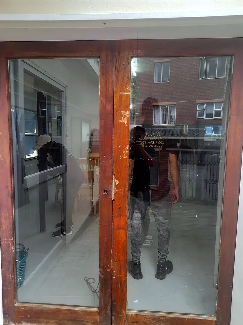 Before: weathered timber double entrance doors