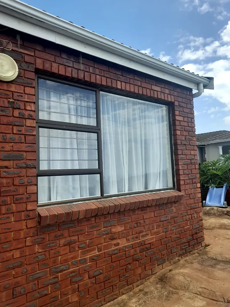 Bronze aluminium window fitted in a face-brick wall