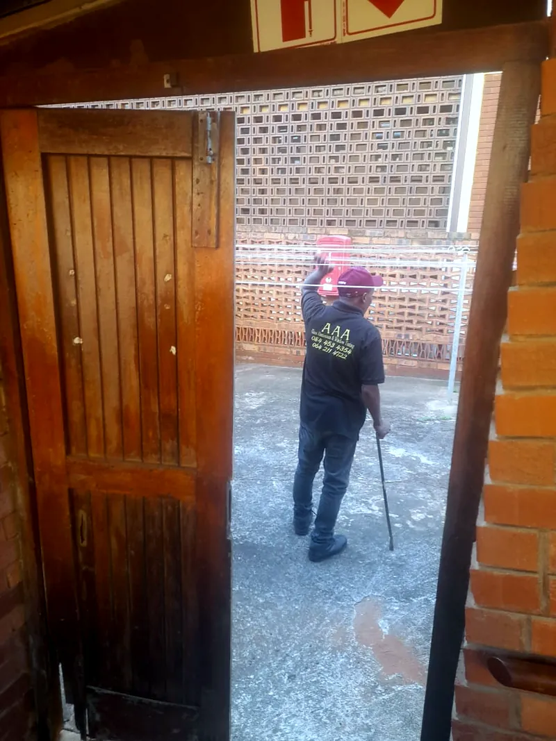 Old timber door being taken out before an aluminium replacement